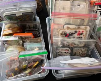 Completed fishing lures and extensive lure-making supplies: feathers, fur, hooks, line