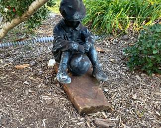 VINTAGED YOUNG CHILD SITTING WITH BALL YARD ART.