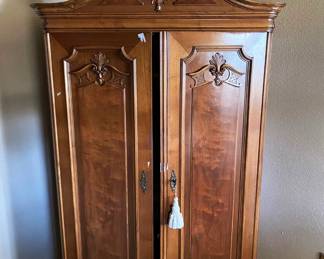ANTIQUE ORNATE ARMOIRE WITH LOWER DRAWER.