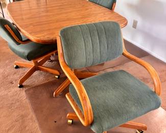 Caster dining table with rolling chairs 