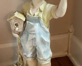 Little Boy Holding Bird house