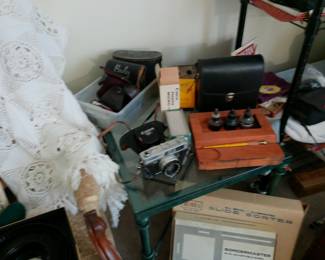 various camera equipment, projector for slides, and screen for presentations. calligraphy/ fountain pen set.