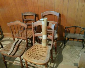 project condition victorian and american ladder back cane chairs. as well as a bag of caning materials. plant stands, glass coffee table with matching end table.