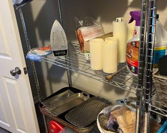 Four silver four shelf shelving units and one taller shelving unit with four shelf’s 