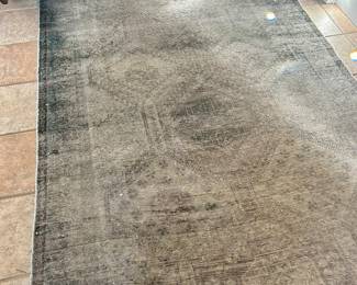 Faded and worn antique Middle Eastern rug