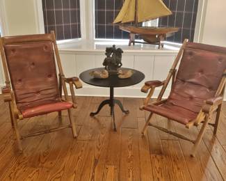 Pair of Antique Leather Campaign Chairs with a Pedestal Side Table; Ship in background MAY be for sale, it's named: "Lethal Four,"  jury still out.  Decoys for sale.