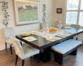 wood dining table with suede covered dining chairs and benches