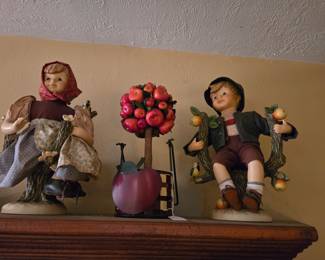 Hummel dolls sitting in apple trees