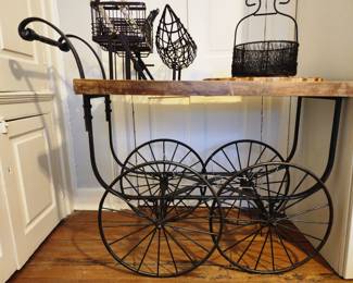 Wooden and metal carriage console. Wheels are not mobile. 