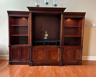 R1 - $150 - 3 Piece Basset Media Cabinet. Both ends have lights. Moves in 3 pieces. End Sections are 29.5" wide x 20" deep x 74.5" tall. Middle part is 45" wide at the main part (50.5" with trim) x 23.5" deep ( 27" deep with trim) x 79" tall.