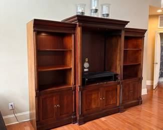 R1 - $150 - 3 Piece Basset Media Cabinet. Both ends have lights. Moves in 3 pieces. End Sections are 29.5" wide x 20" deep x 74.5" tall. Middle part is 45" wide at the main part (50.5" with trim) x 23.5" deep ( 27" deep with trim) x 79" tall.