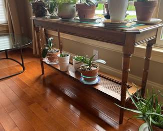 R23 - $65 - LANE furniture sofa table with rattan accents. Top has glass over rattan. Measures 52" wide x 17" deep x 28" tall.