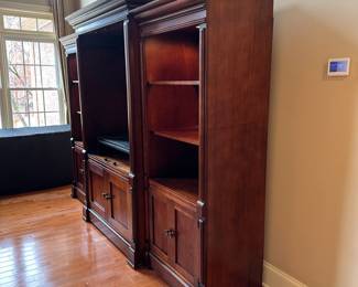 R1 - $150 - 3 Piece Basset Media Cabinet. Both ends have lights. Moves in 3 pieces. End Sections are 29.5" wide x 20" deep x 74.5" tall. Middle part is 45" wide at the main part (50.5" with trim) x 23.5" deep ( 27" deep with trim) x 79" tall.