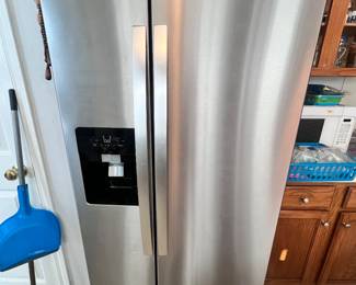 Whirlpool side by side stainless steel fridge with ice and water dispenser. Less than 6 months old. 