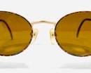 Vintage Guess GU 898 Round Sunglasses with Gold-Tone Frames and Brown Lenses.
