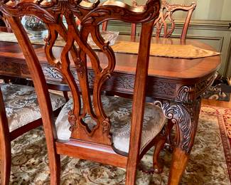 Unusual Table and 8 chairs carved not only on the front but also on the back of the chairs so that you can enjoy them from across the room when not seated at the table.