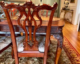 Unusual Table and 8 chairs carved not only on the front but also on the back of the chairs so that you can enjoy them from across the room when not seated at the table.