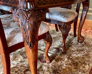 Unusual Table and 8 chairs carved not only on the front but also on the back of the chairs so that you can enjoy them from across the room when not seated at the table.