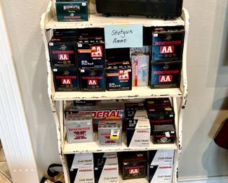 Two shelves full of shotgun shells and rifle ammunition. 
