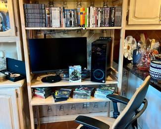 Lots of DVDs, office desk and chair.