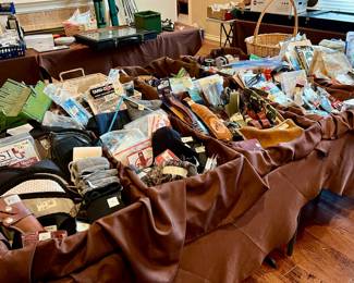 4 tables full of hunting and fishing gear and gadgets. 