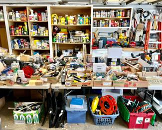 Garage with lots of tools and chests. 