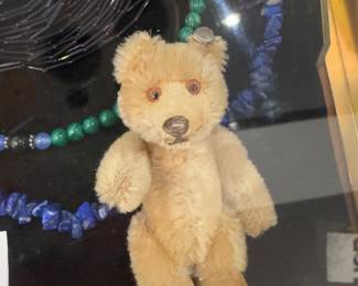 Stuffed bear, beaded necklaces