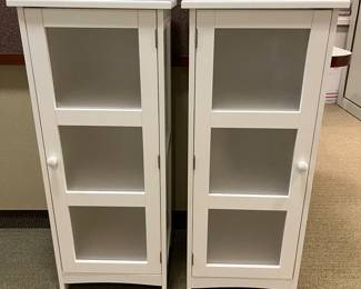 Matching white bathroom/bath cabinets.