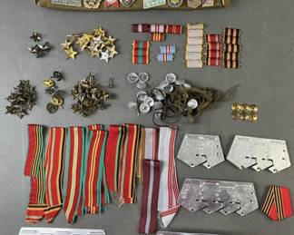 Lot 134 | Soviet Pins Ribbons, Supports for Medals & More
