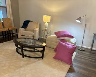 oval glass top table, Laz-Boy chair, storage ottoman. large pillows, counter high bar stools