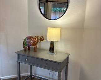 round mirror, small table / desk with drawers