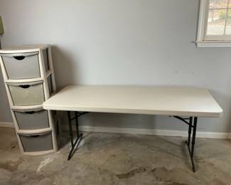 Durable Lifetime folding table and Sterilite 4drawer plastic storage unit. 