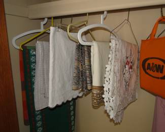 A whole host of vintage and Mid Century Modern tablecloths and an A&W seat cushion