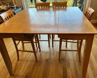 Tall cafe table with extra leaf + 6 chairs.  Very sturdy, but top needs TLC