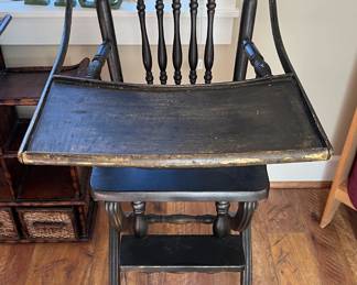 High chair on wheels, cane seat, spindle back + rungs
