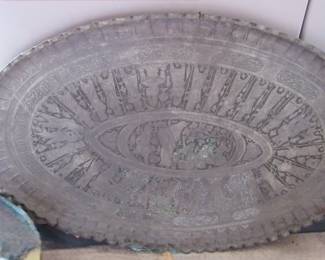 Large oval silver platter or tray. it could also be a table top? 