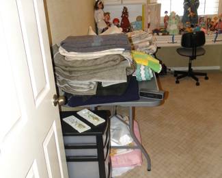 In the foreground we have some very nice wool, all wool, in amazing shape blankets, in the background we have some dolls