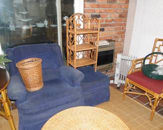 That is a blue, very comfortable chair and matching ottoman, with a basket and shelving system on them both