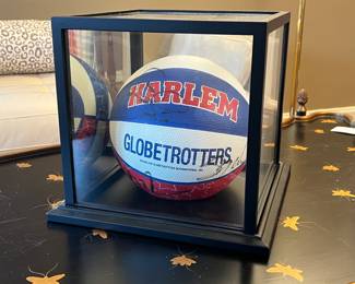 Multi signed Harlem Globetrotters basketball with glass display case