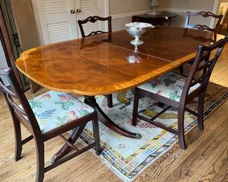 Banded double pedestal dining room table with three leaves and pads