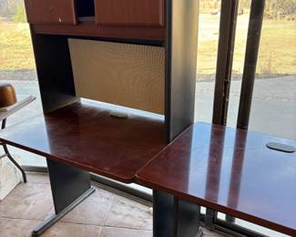 Office Desk with Hutch
A functional office desk with a built-in hutch featuring storage cabinets. The deep wood finish is perfect for a home office or workspace. Sturdy and practical, it offers plenty of storage and organization.