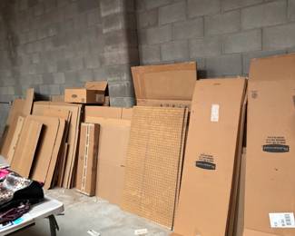 Cardboard and Pegboard Supplies
A stack of flattened cardboard boxes and pegboard pieces, useful for shipping, moving, or organizing tools in a garage or workshop.