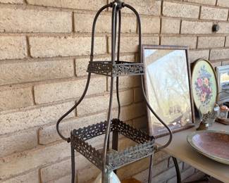 Metal Lantern and Decorative Accessories
A vintage-style metal lantern with intricate cut-out details, ideal for outdoor or indoor use. Surrounding it are framed artworks, plates, and decorative accents, adding charm and character to any space.