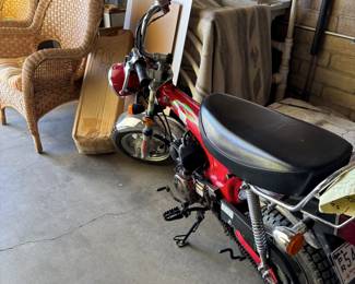 Vintage Honda Clone Mini Bike
A red Honda Clone mini bike with a sleek seat and chrome accents, perfect for collectors or enthusiasts looking for a fun ride. In the background are wicker chairs and assorted home items.