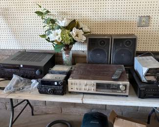 intage Electronics Collection
A variety of vintage stereo receivers, speakers, and audio components, accompanied by a floral arrangement for décor. Ideal for audiophiles or anyone seeking classic sound systems.