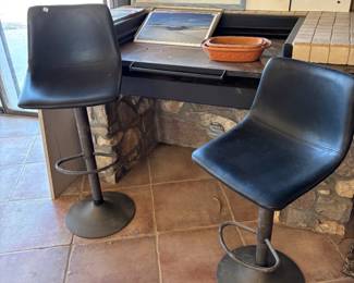 Modern Black Bar Stools and Art Collection
Two sleek black bar stools with a minimalist design paired with an assortment of framed artwork and pottery, making it perfect for a stylish kitchen or studio.