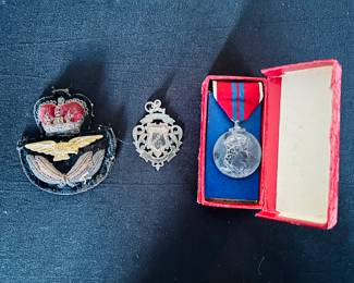 RAF helmet emblem (L) and Queen Elizabeth II commemorative coronation silver medallion