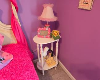 Underneath the pink is a beautiful day bed and this little matching side table. What little girl doesn't love pink. If pink isn't your thing though, there's a precious little girls room here that with just a little imagination you could make all your own.