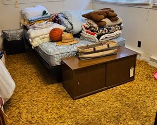 adjustable bed, record holder with legs removed, linens