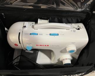 Simple Singer sewing machine in wheeled case